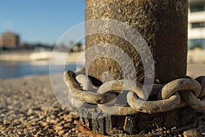 Rusty chains around a bollard