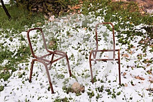 Rusty chairs on snow.