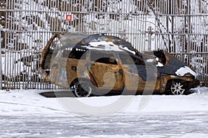 Rusty charred body of a car on a black background