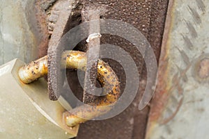 Rusty closed padlock on door