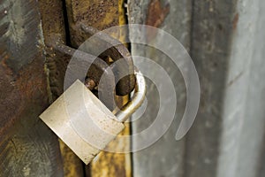 Rusty closed padlock on door