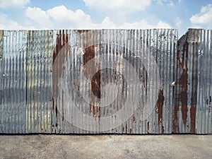 Rusty corrugated metal fence