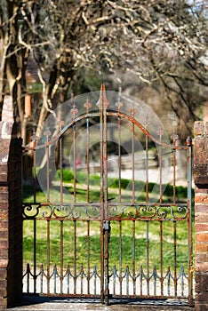 A rusty decorative iron gate.
