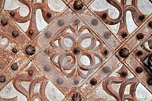 Rusty details of wrought iron medieval door