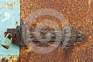 Rusty Door Bolt With a Padlock Close Up