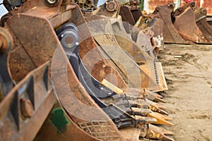 Rusty excavator buckets in a truck yard