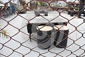 Rusty fence with table and chairs