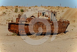 Rusty fishing boat lying in the sand