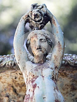 Rusty garden scupture figuring a woman from the sea.