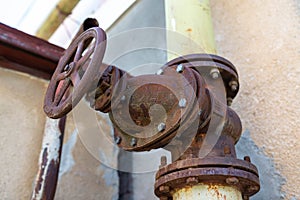 Rusty gas pipe connections on old industrial building