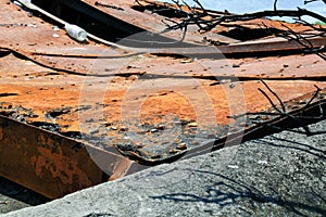 Rusty gate studded twisted sheet metal.