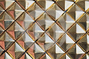 Rusty golden diamonts pattern. Plastic background