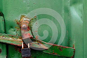 Rusty green metal texture of cargo container with padlock
