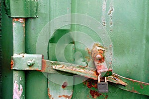 Rusty green metal texture of cargo container with padlock