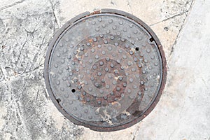 Rusty, grunge manhole cover NOT isolated