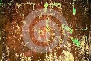 Rusty and grungy metal iron plate wall with the typical ferric oxide red color and with green peeling coating texture background