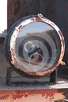 the rusty headlight of an old train