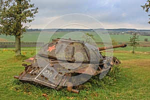 A rusty heavy Soviet IS-3 tank without tracks is rusting in the field