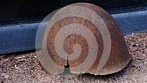 rusty helmet lies on the grave of a soldier