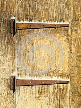 Rusty hinges on an old wooden door