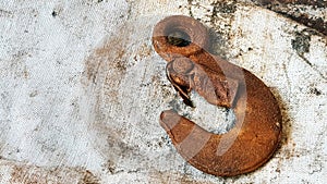 Rusty hook on a protective gloves closeup. Idustrial background with copy space