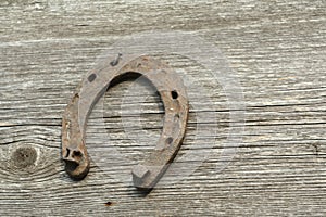 Rusty horseshoes on a wooden background - rustic scene in a country style.