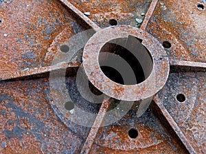 Rusty hub of a metal steam engine wheel