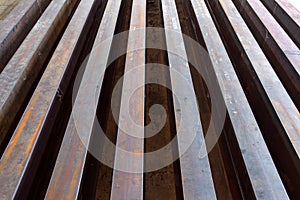Rusty I-beams arranged in rows