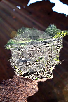 Rusty industrial old broken metal can as a frame