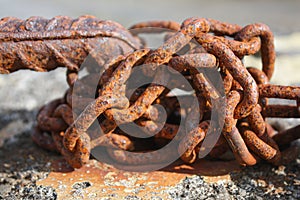 Rusty iron chain of an abandoned boat