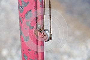 The rusty iron pulley with blue sky background .