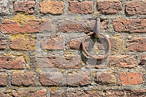 Rusty iron ring in old brick wall