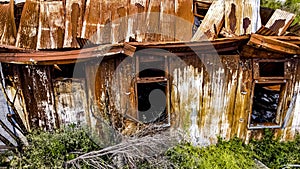 Rusty iron shed with a fallen roof