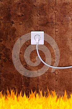 Rusty iron wall with an electrical outlet and fire