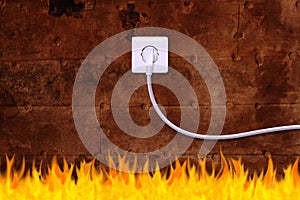 Rusty iron wall with an electrical outlet and fire
