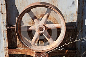 Rusty iron wheel in junkyard