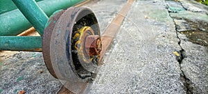 The rusty iron wheel of the old gate of an old abandoned building