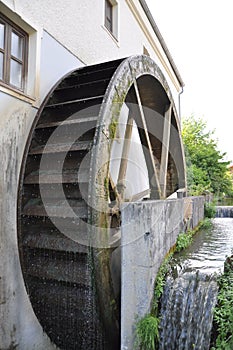 Rusty iron wheel of old mill water.Water Wheel - motion blur on wheel.