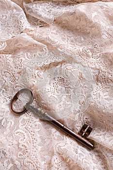 Rusty key on lace
