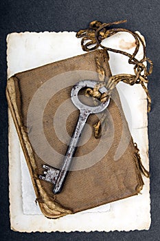 Rusty key, old book and empty photography