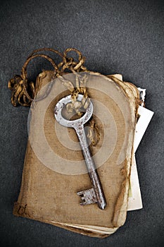 Rusty key, old book and empty photography as a memories metaphor