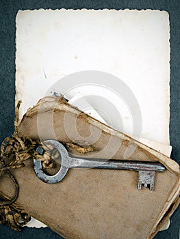 Rusty key, old book and empty photography