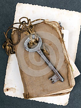 Rusty key, old book and empty photography