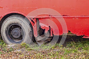 The rusty, leaky bottom of the vehicle, painted over with red paint