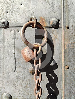 rusty lock and chain on metal door