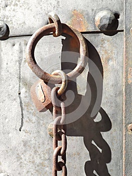 rusty lock and chain on metal door