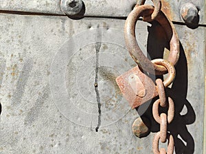 rusty lock and chain on metal door