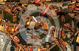 Rusty locks on the railings of a bridge