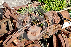 A rusty machine with cogs, chains and wheels