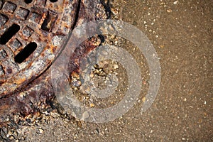 Rusty manhole cover with beautiful colours and textures.